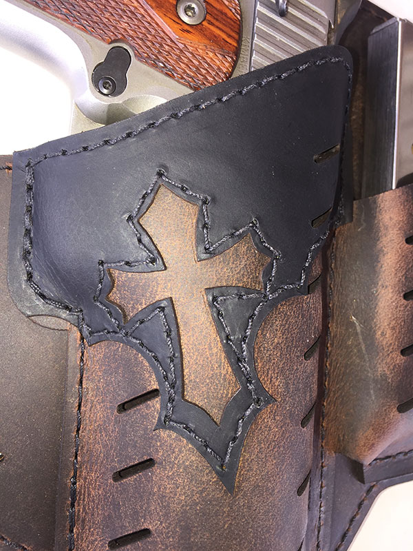 Black overlay has a cutout in the shape of a Crusader’s cross.
