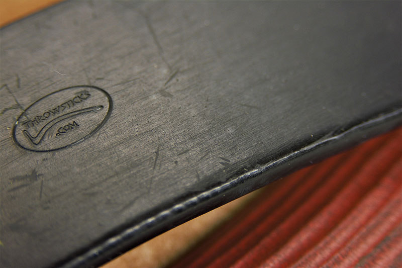 Scratches, dents, and missing paint are all part of the image of a rugged and used throwstick. Paint will eventually wear off and clear core will be exposed. Even gentle use puts significant strain on the finish.