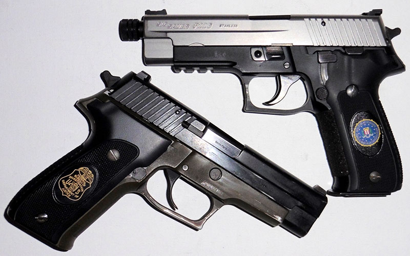 Brace of SIG Sauer P226s with grips emblazoned with FBI shield (top) and FBI agent’s badge. Shield is UV printer colorized image. Badge is CO2 laser etched.