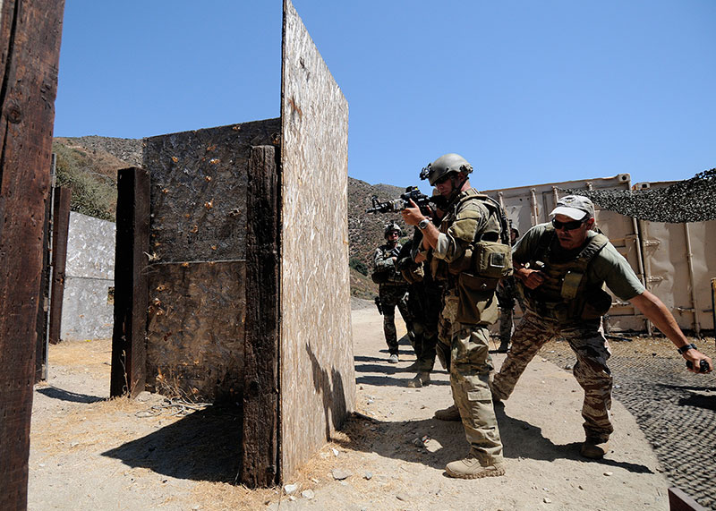 Step, look, pull, throw. Mass Communication Specialist 1st Class James E. Foehl provides cover while Max Joseph, director of TFTT Direct Action Group, deploys flashbang into shoot house. Goal in training is realistic simulation. Photo: U.S. Navy photo by Mass Communication Specialist 3rd Class Adam Henderson / Released