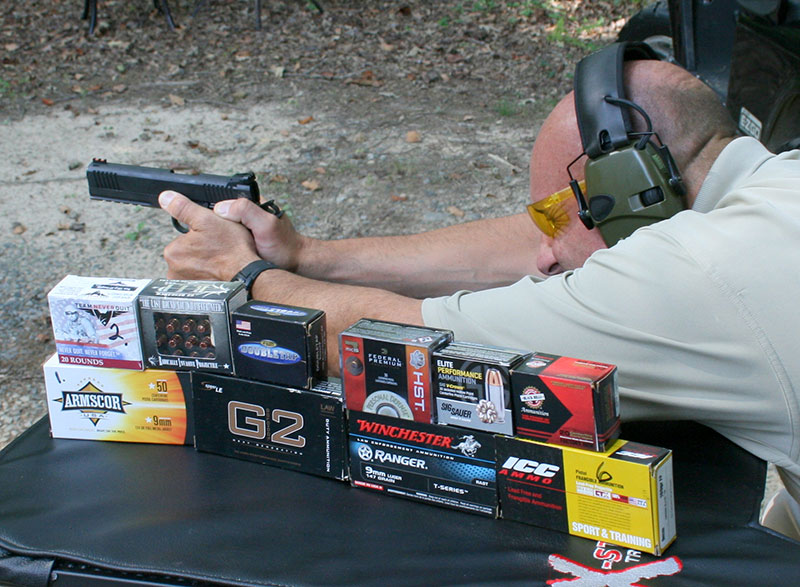 Former FAM Ken Trice fires 25-yard groups from handheld rest. Ammo in foreground was used for evaluation.