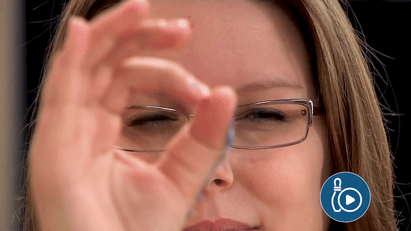 a lady holding her hand up to her face