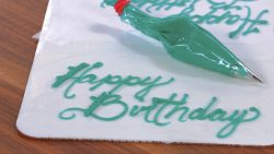 happy birthday cake cursive piping letters