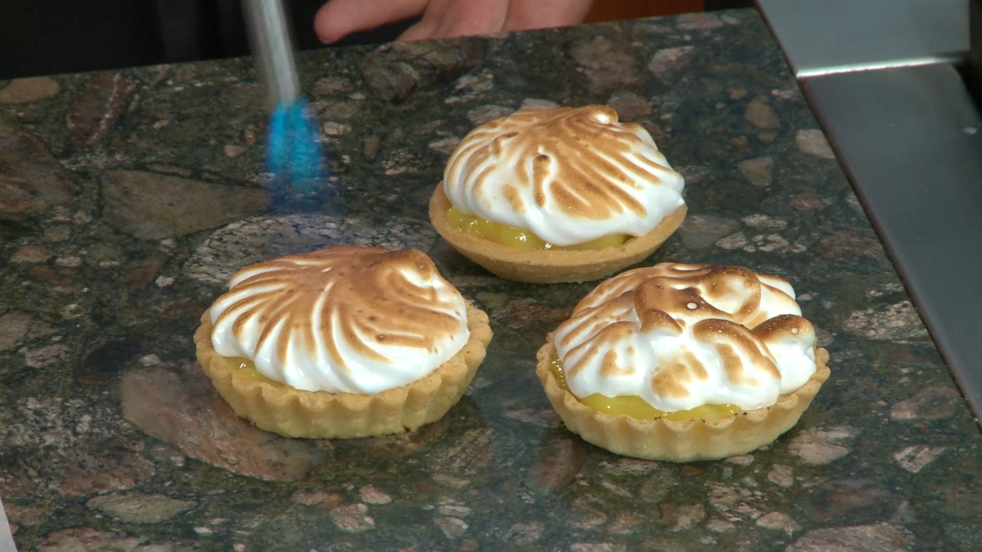 three lemon tartlets with toasted meringue