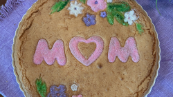 Decorative Snickerdoodle Cookie Tart with a "MOM" design and flowers