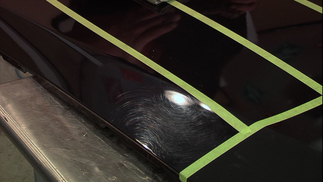 Black car with scratches in the paint