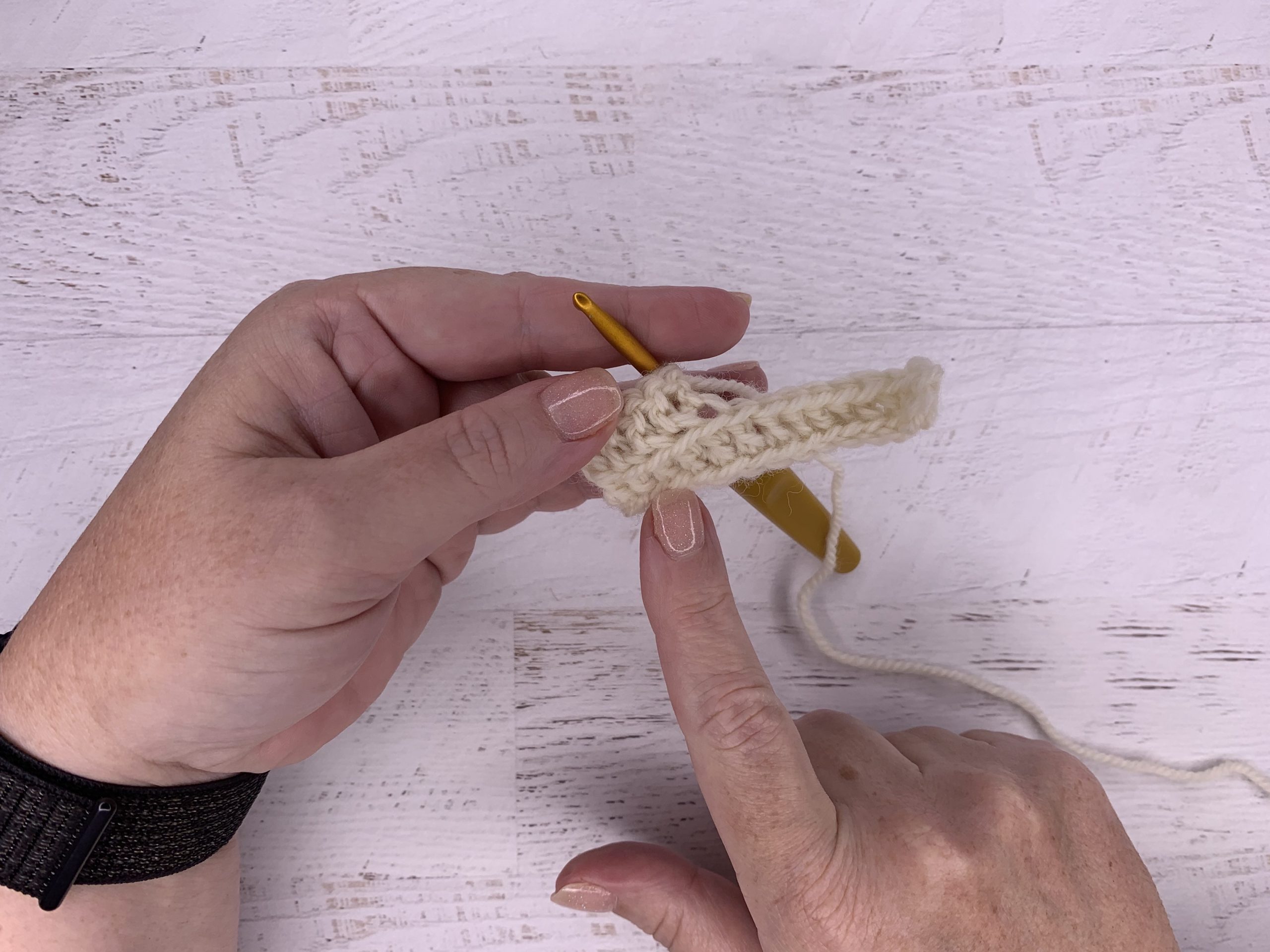 finger showing where the back stitch is