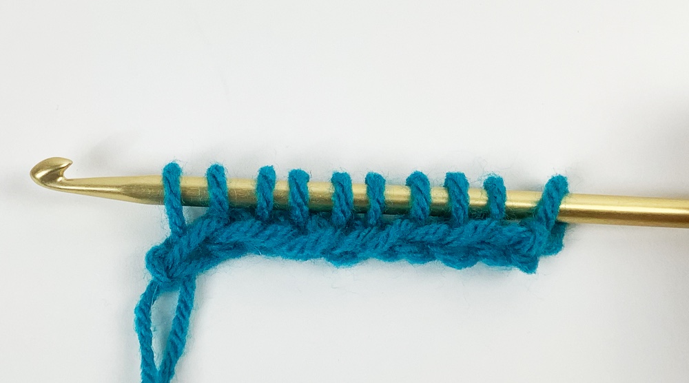 blue yarn on crochet hook