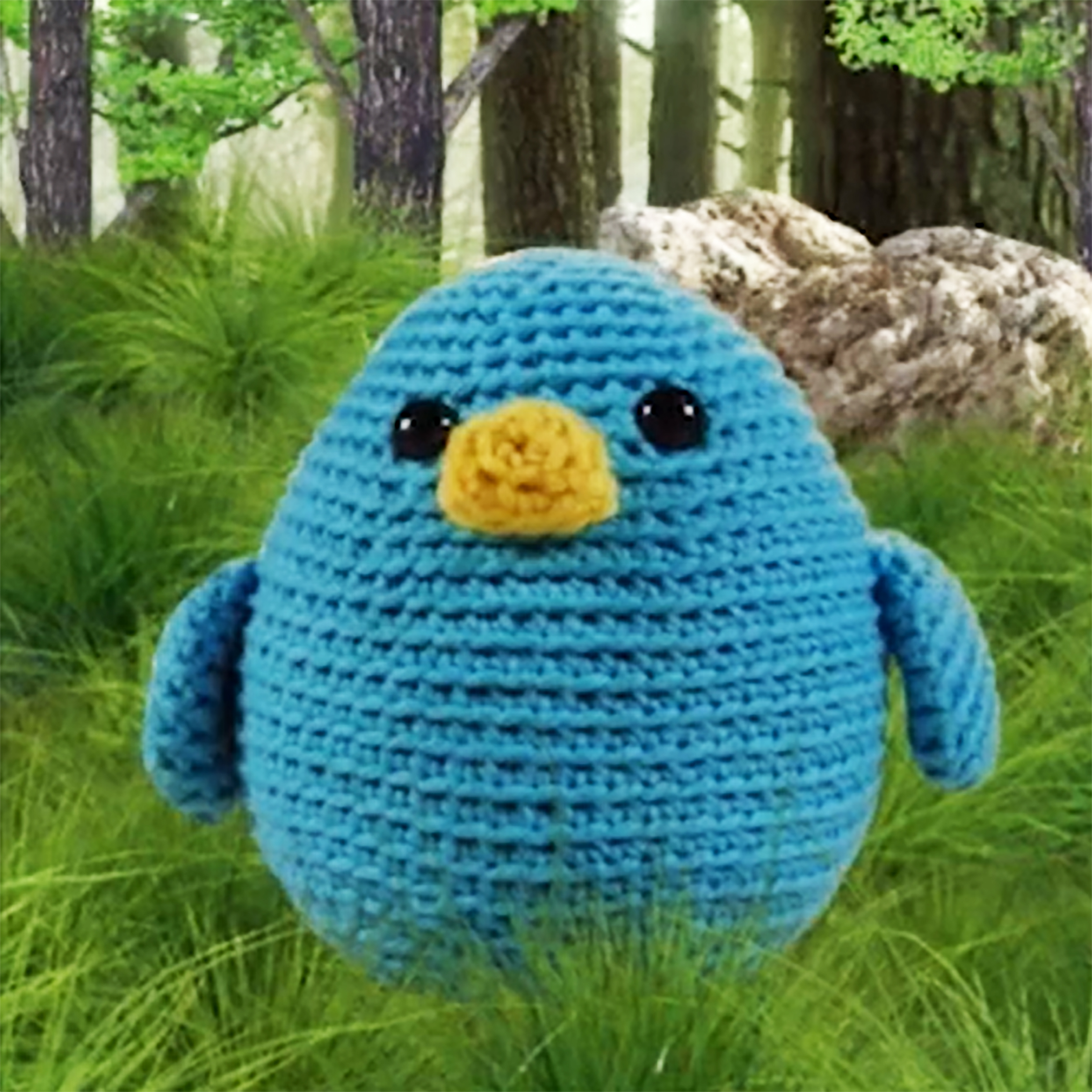 small blue crocheted bird with yellow beak