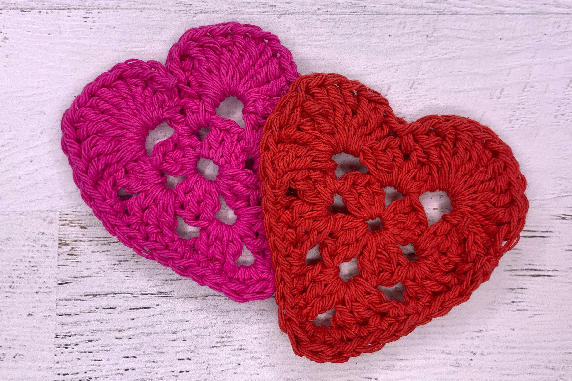 two red crocheted granny hearts