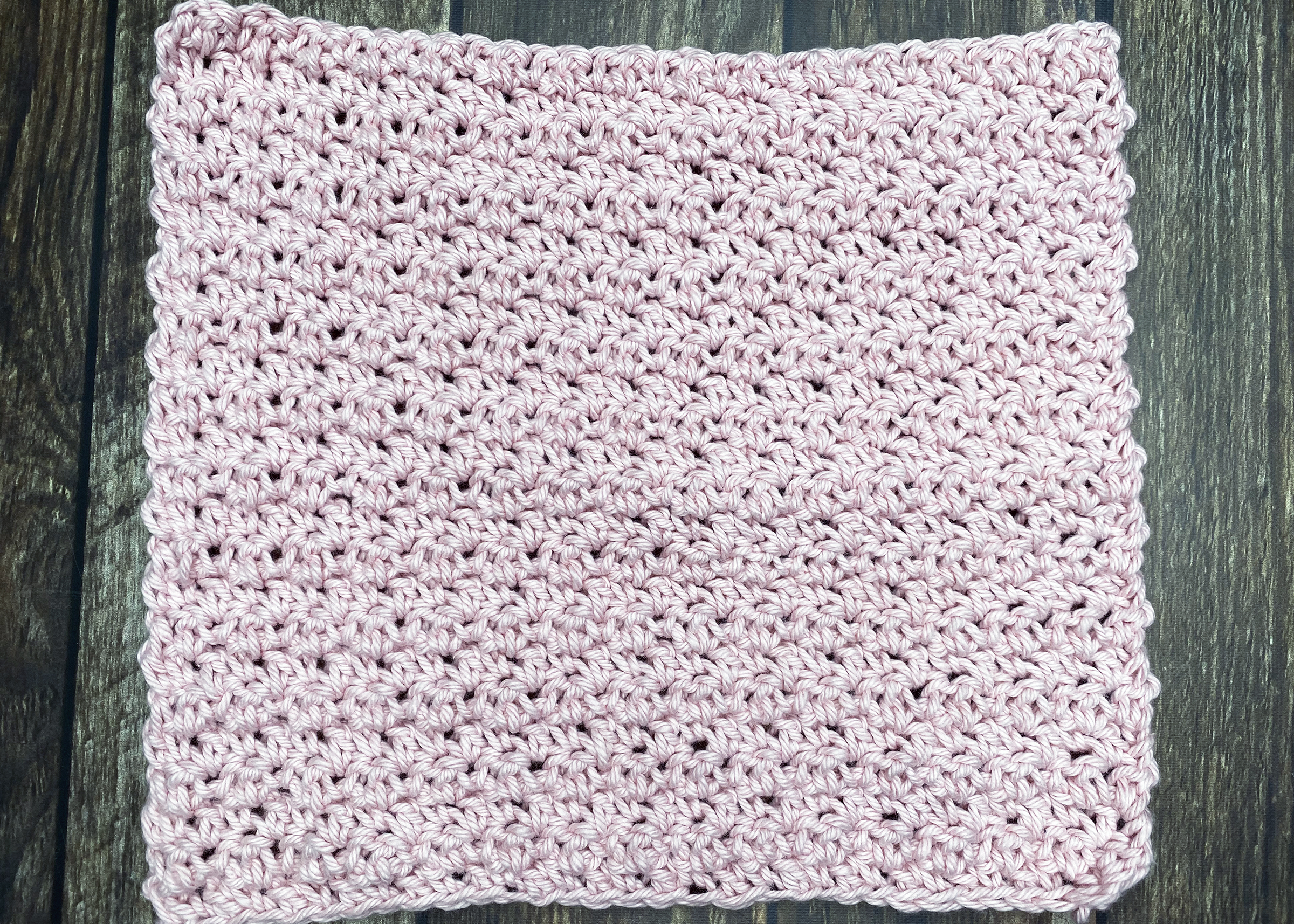close up image of a pink crocheted square