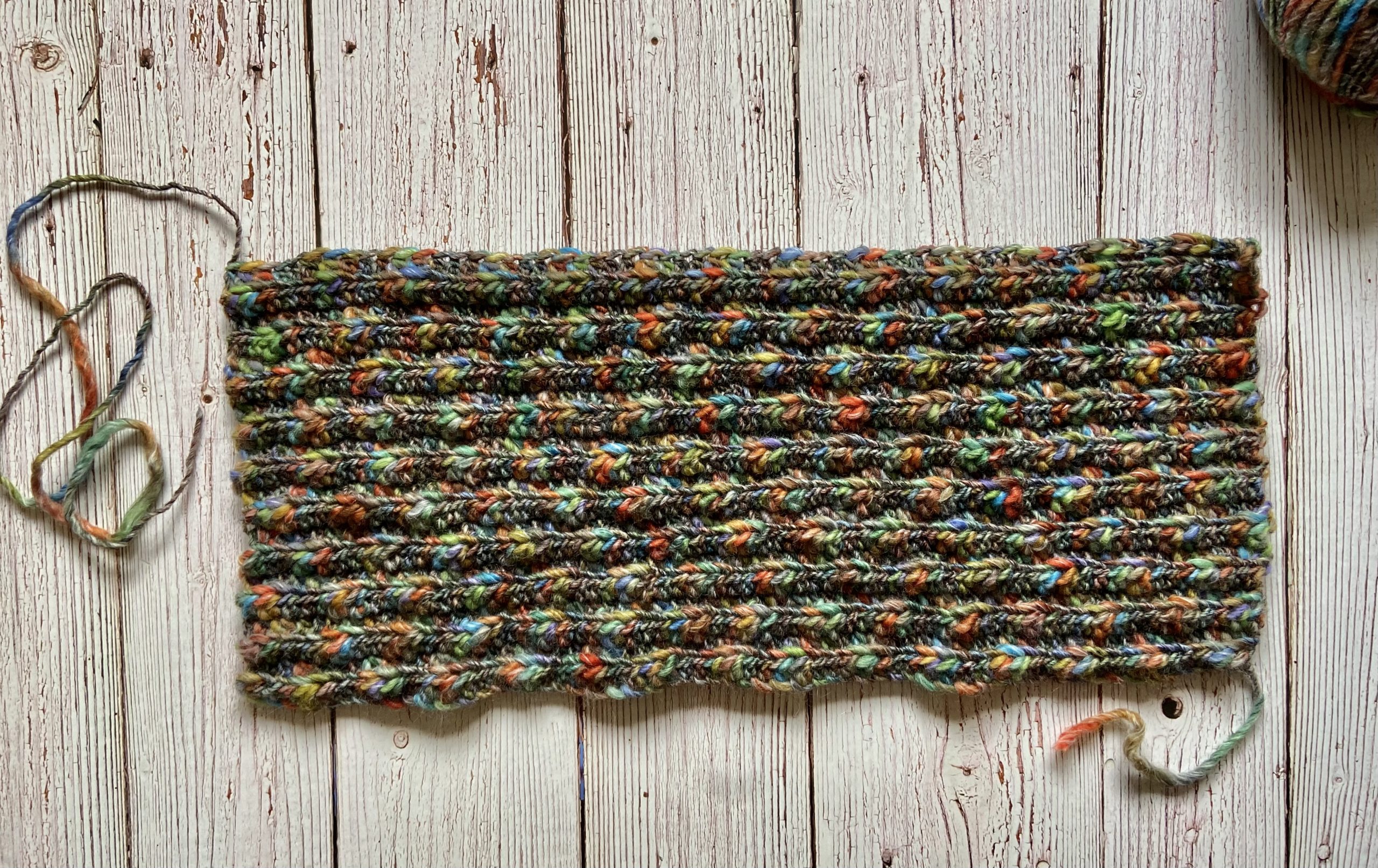 close up image of a crochet project using multi-colored yarn