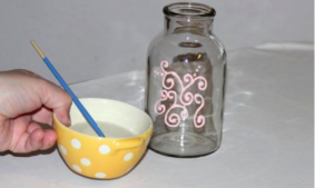 Piping on Glass Bottle Next to Bowl of Water and Brush