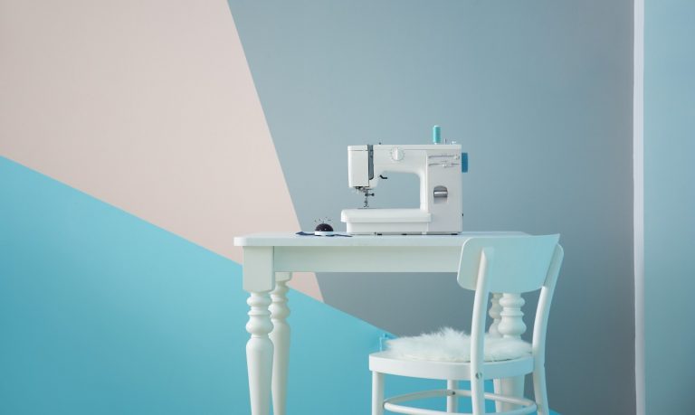 sewing machine in front of geometric painted wall