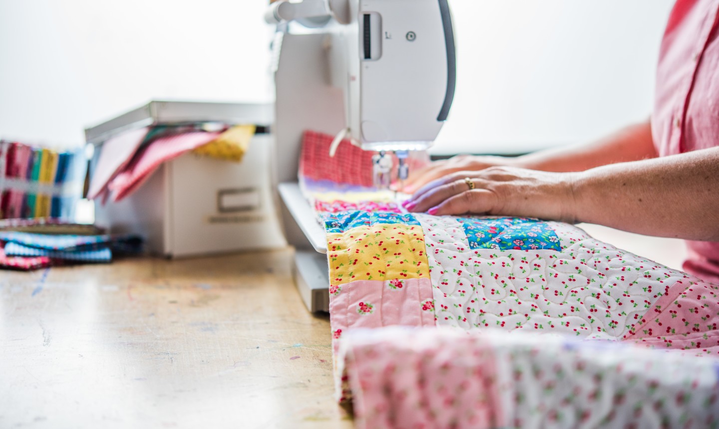 woman quilting on a sewing machine