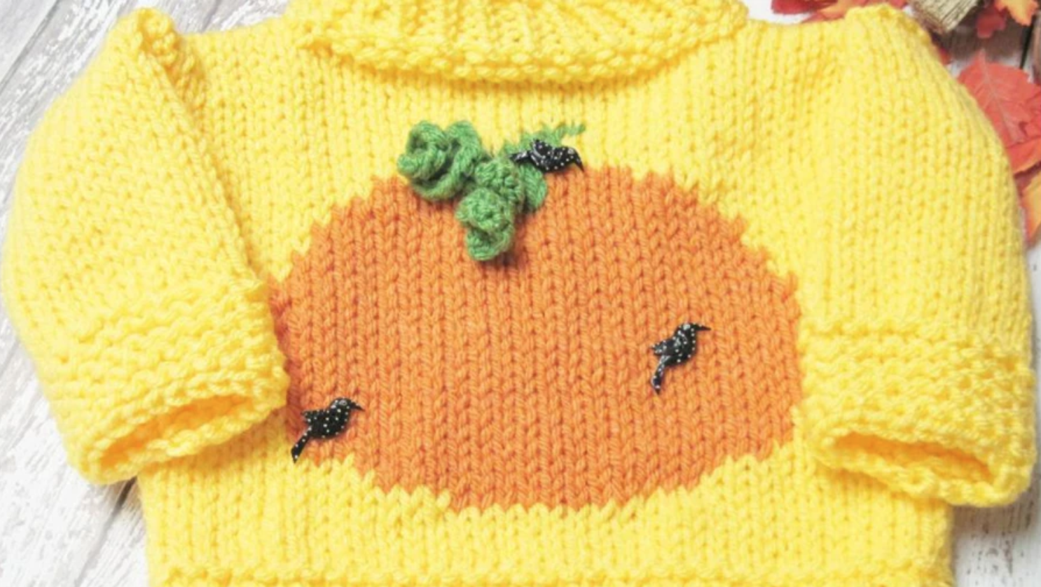 yellow knit sweater with orange pumpkin