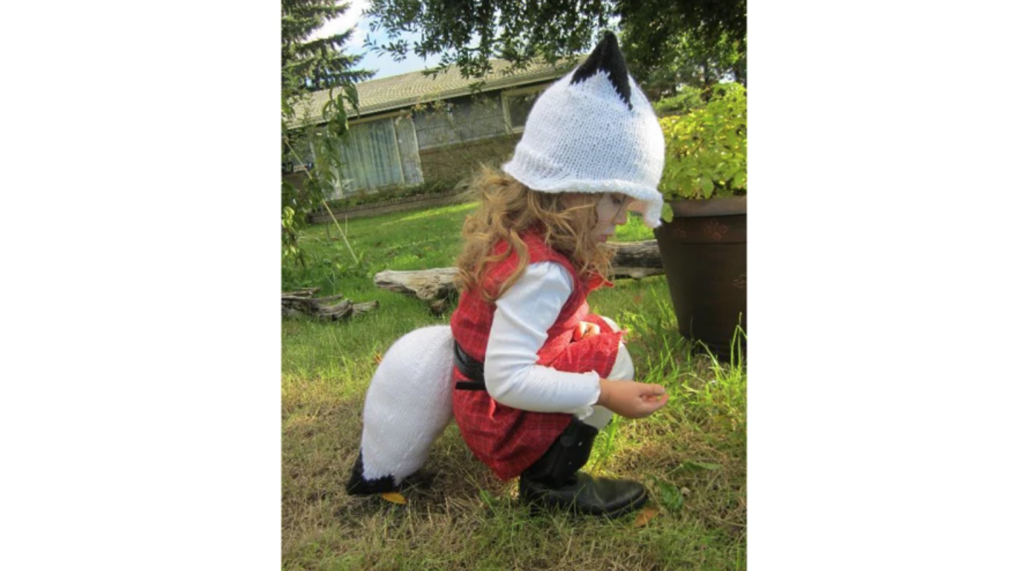 child wearing a winter fox hat and tail