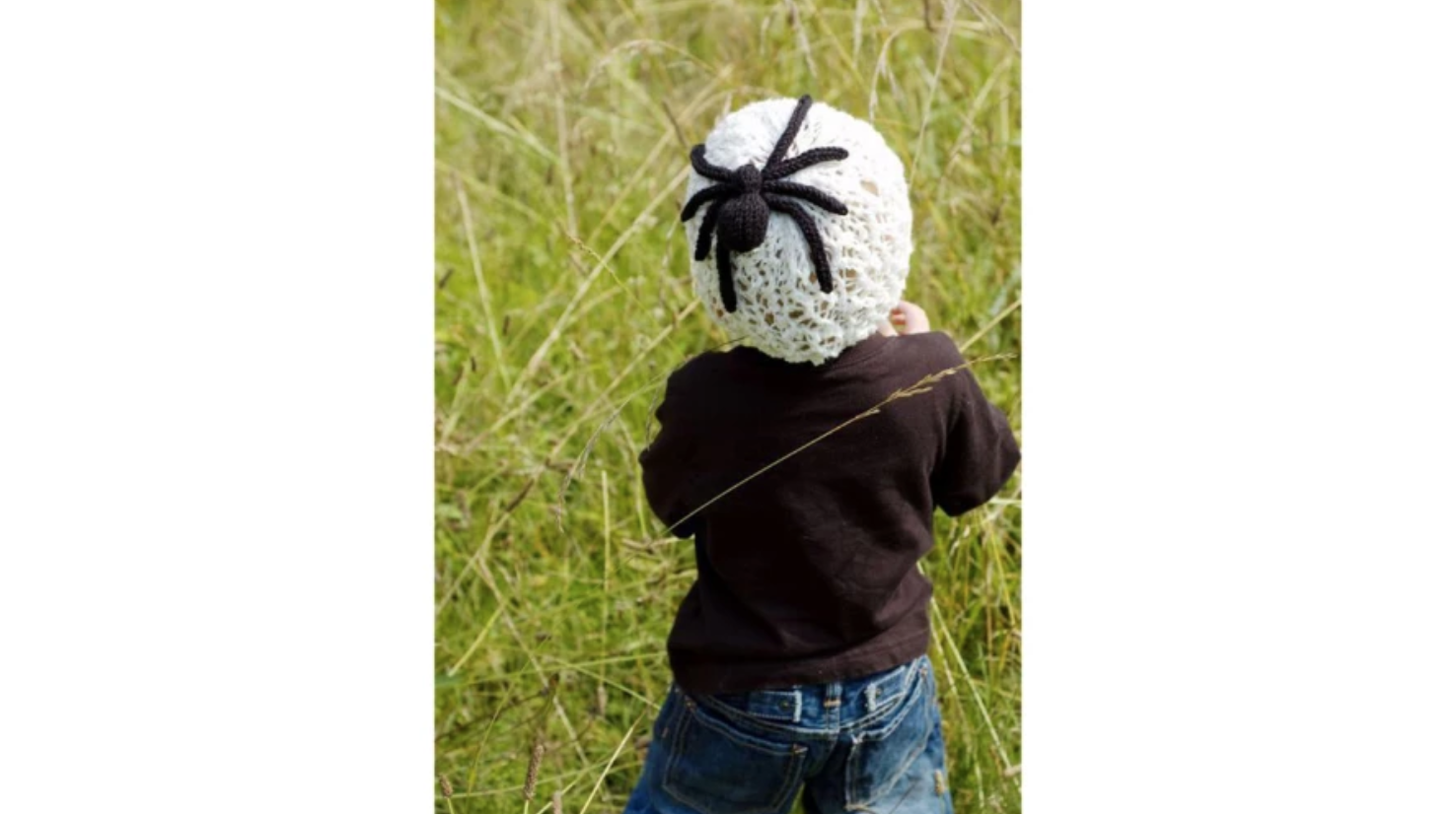 child wearing spider web hat