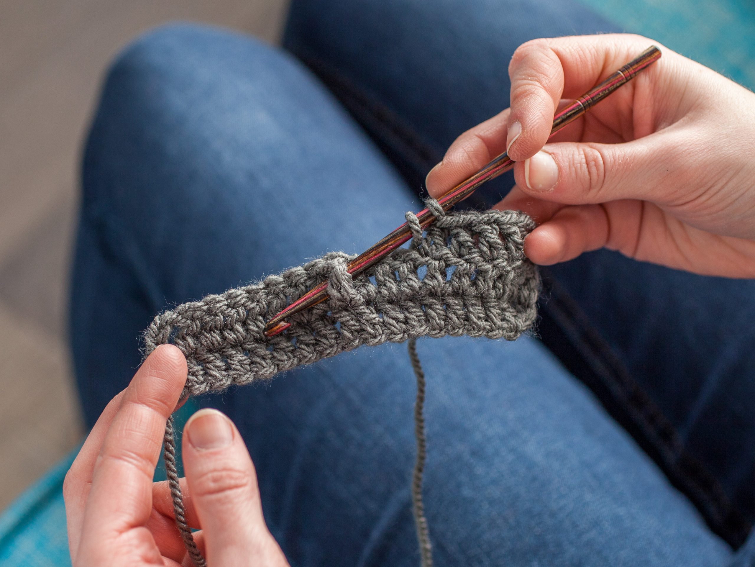 Person crocheting through stitch
