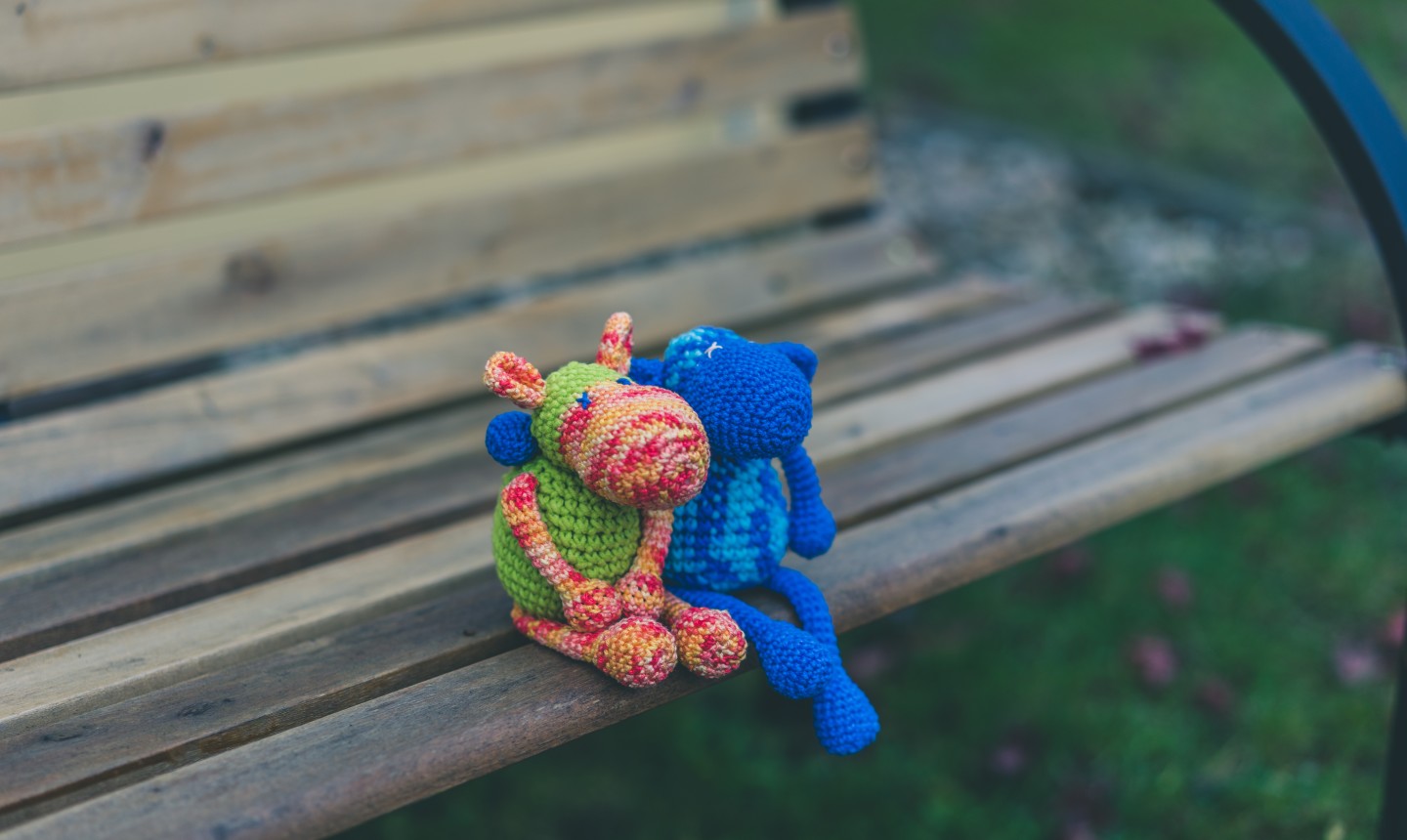 amigurumi figures on a park bench