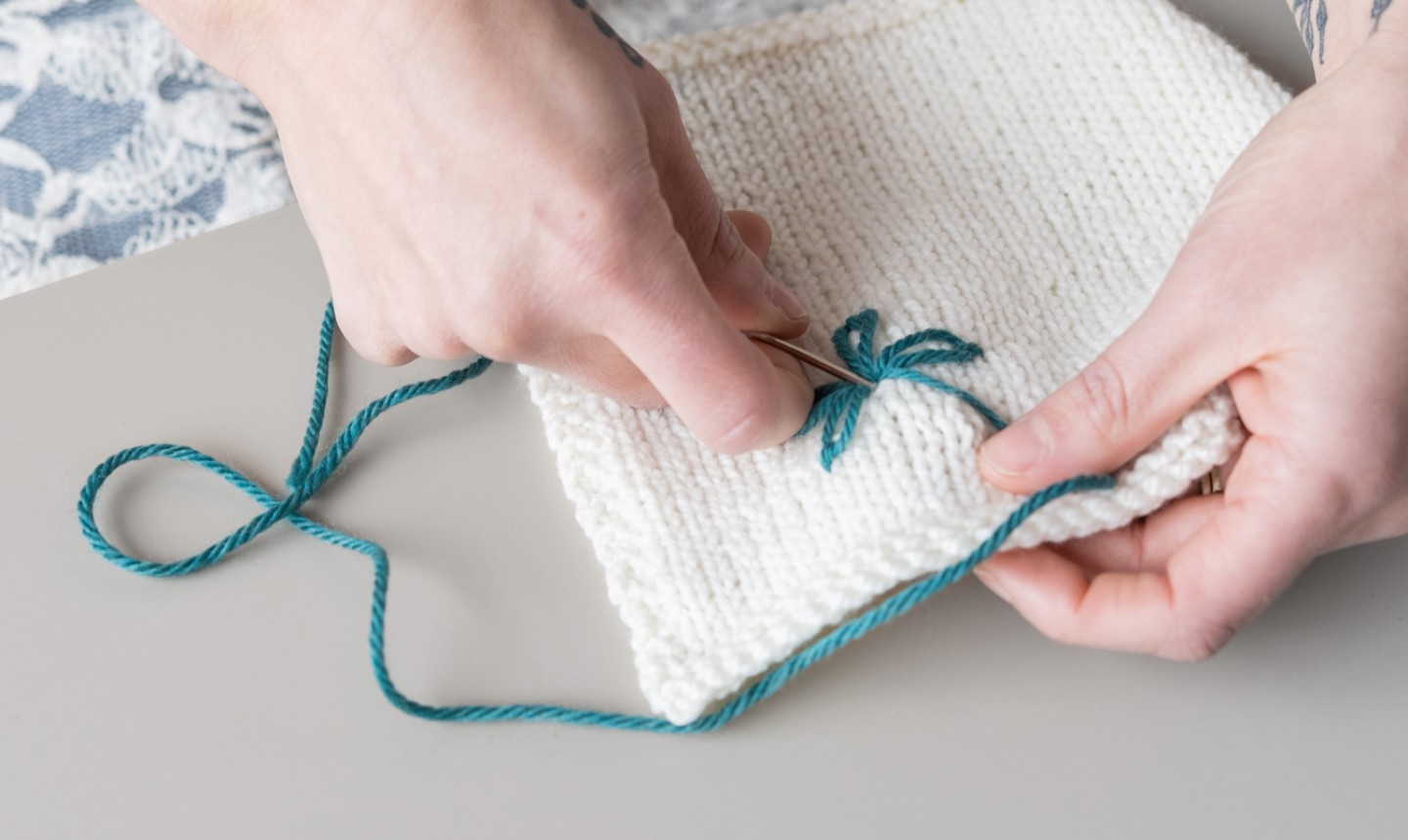 embroidering yarn on sweater