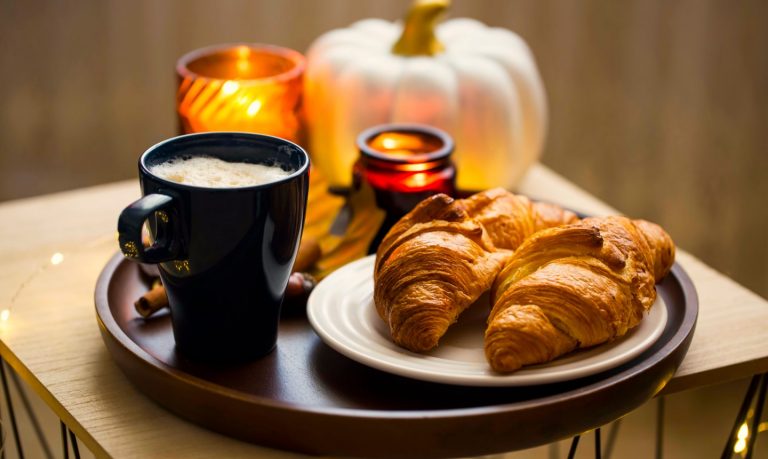 Pumpkin pie croissant on a tray with candles
