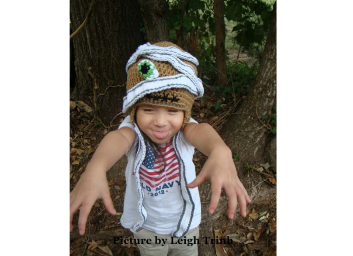 boy wearing crochet mummy hat