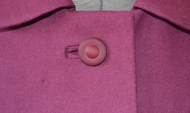 bound buttonhole on pink garment