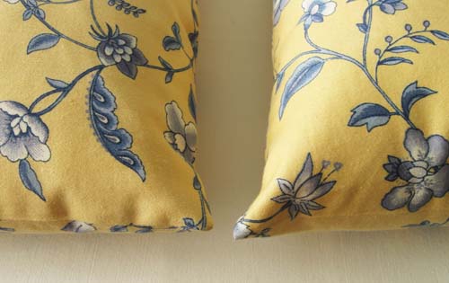 Yellow pillows with blue flowers and leaves