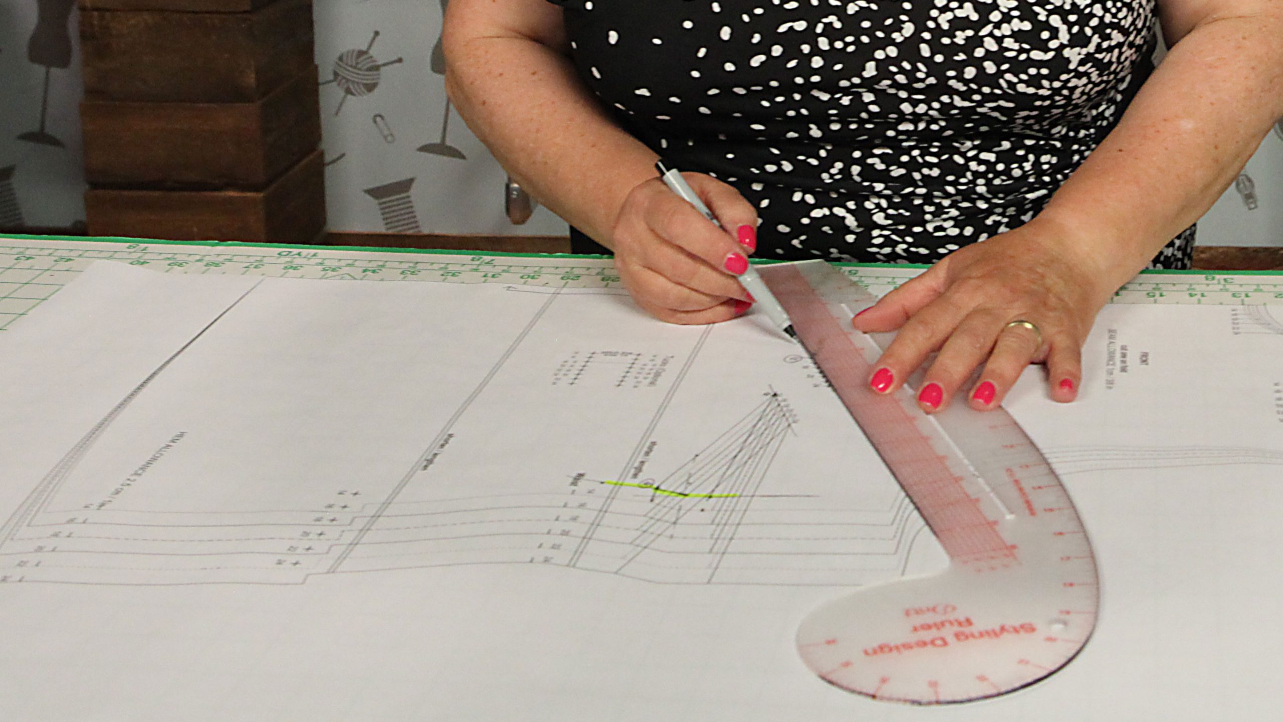 Women using curved ruler