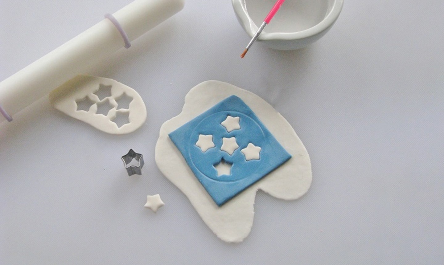 placing white stars in blue fondant cut out
