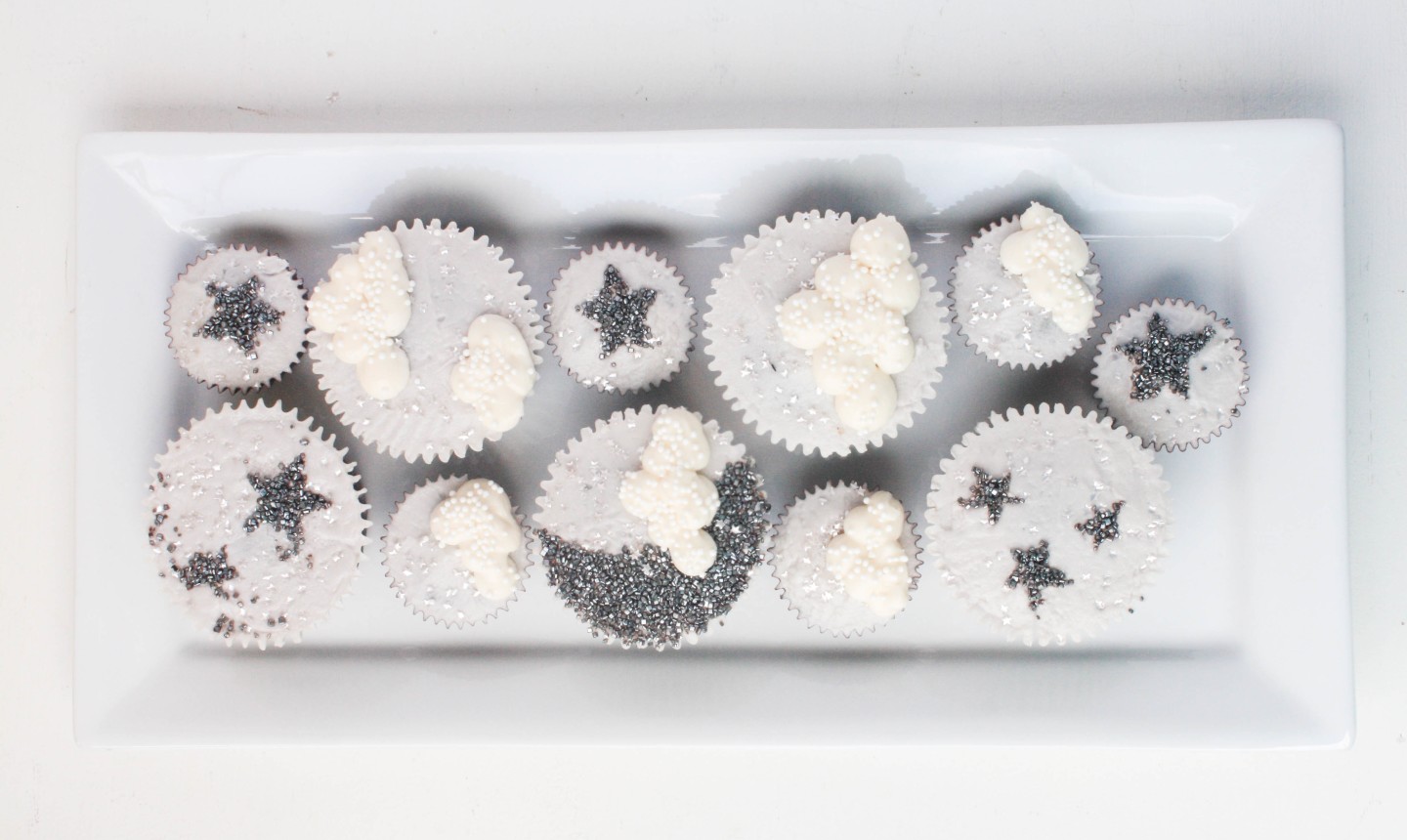 sparkly moon and stars cupcakes on a platter