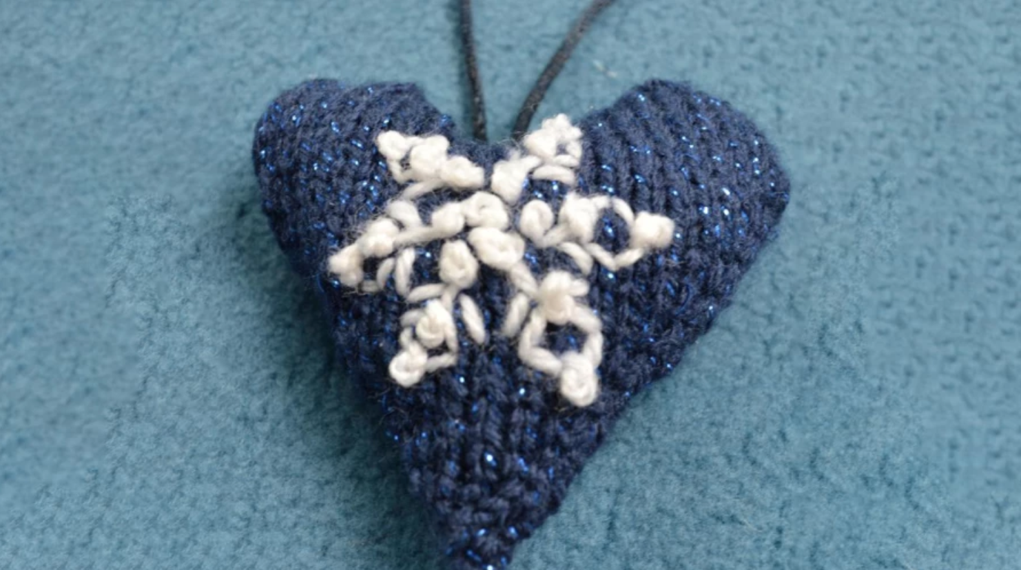 blue knit heart with embroidered snowflake