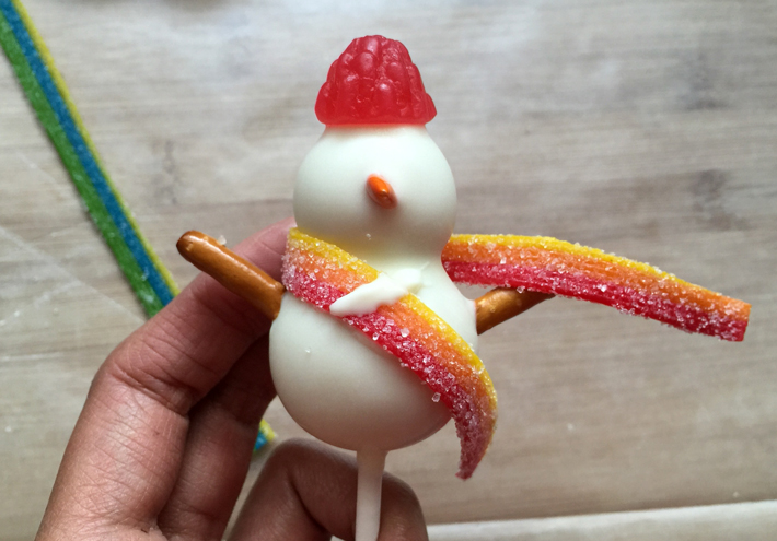 wrapping snowman cake pop in scarf