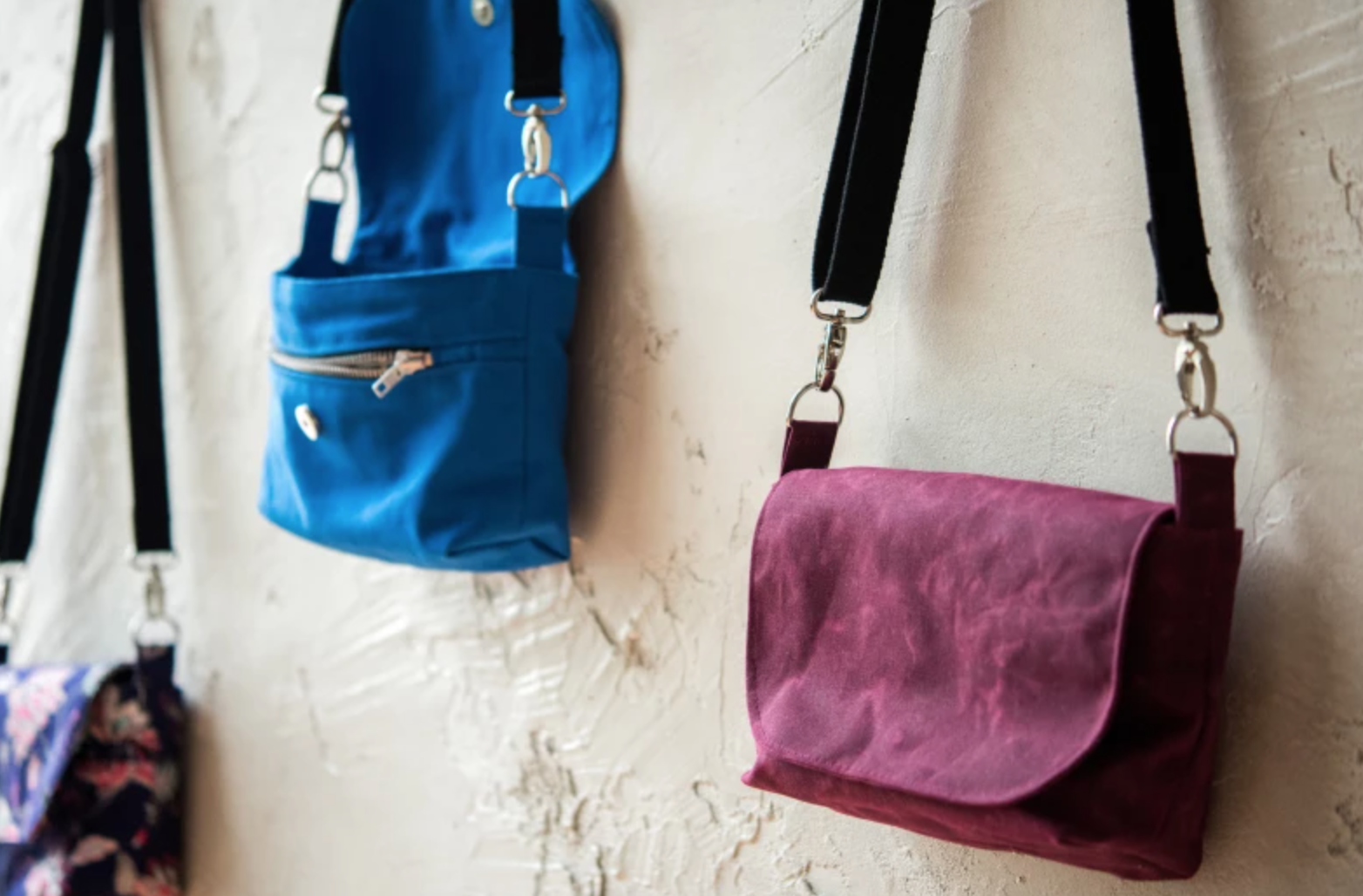 cross-body bags hanging on wall