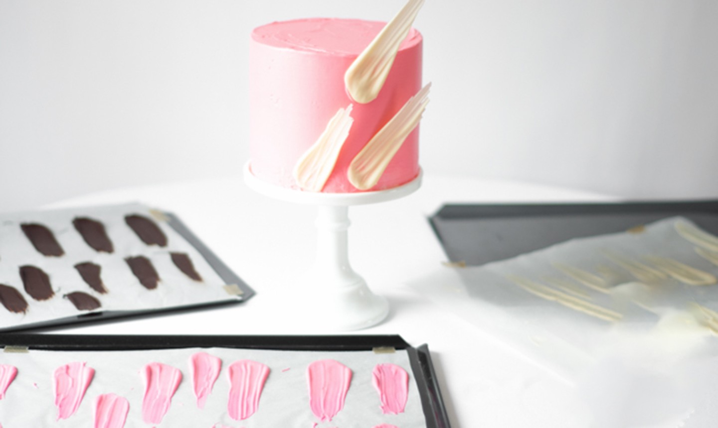 placing candy melt brush strokes onto cake