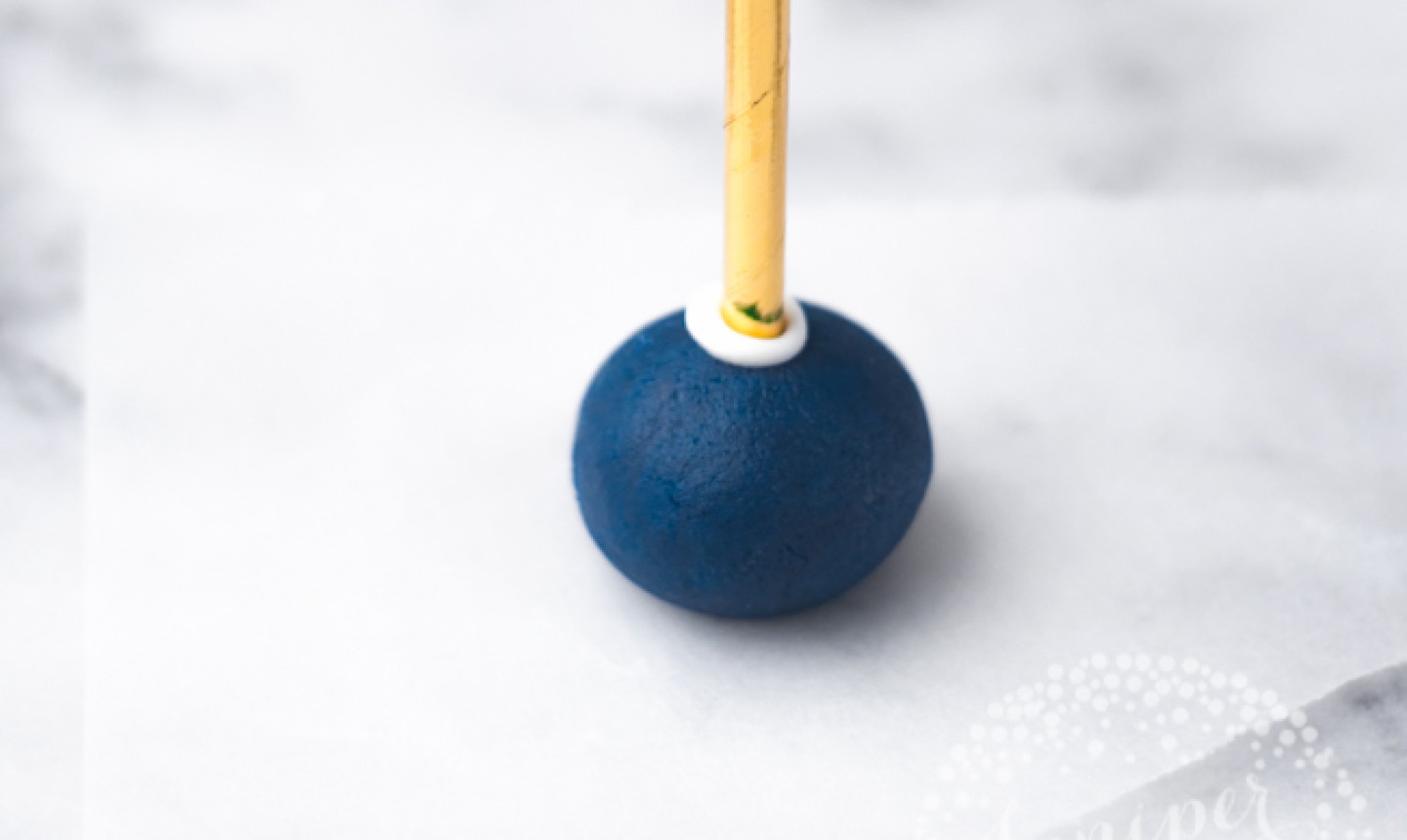 blue cake pop dough on stick