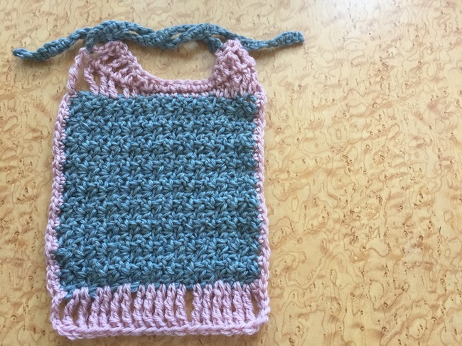 Crochet an Adorable Baby Bib Using the Simple Wattle Stitcharticle featured image thumbnail.