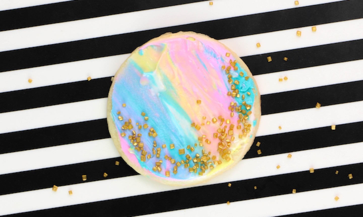 sprinkles on a watercolor sugar cookie