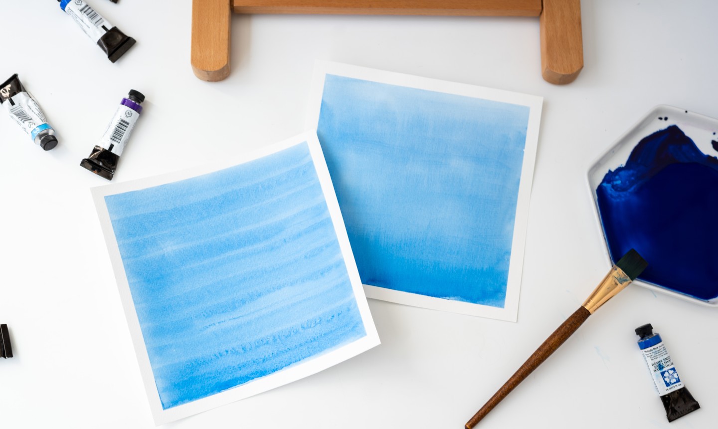 two papers with blue watercolor washes