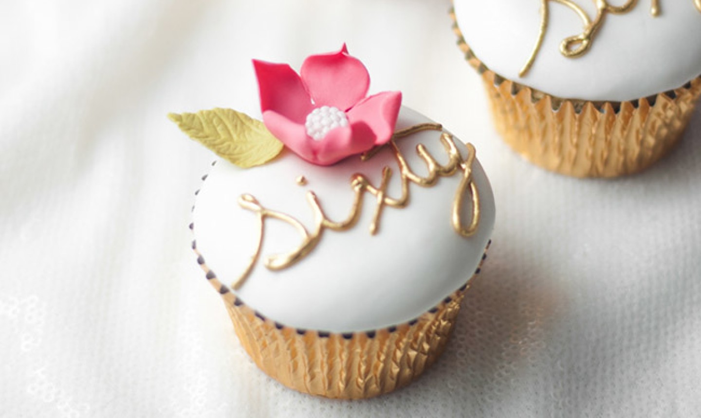 fancy cupcake with sixty written in cursive