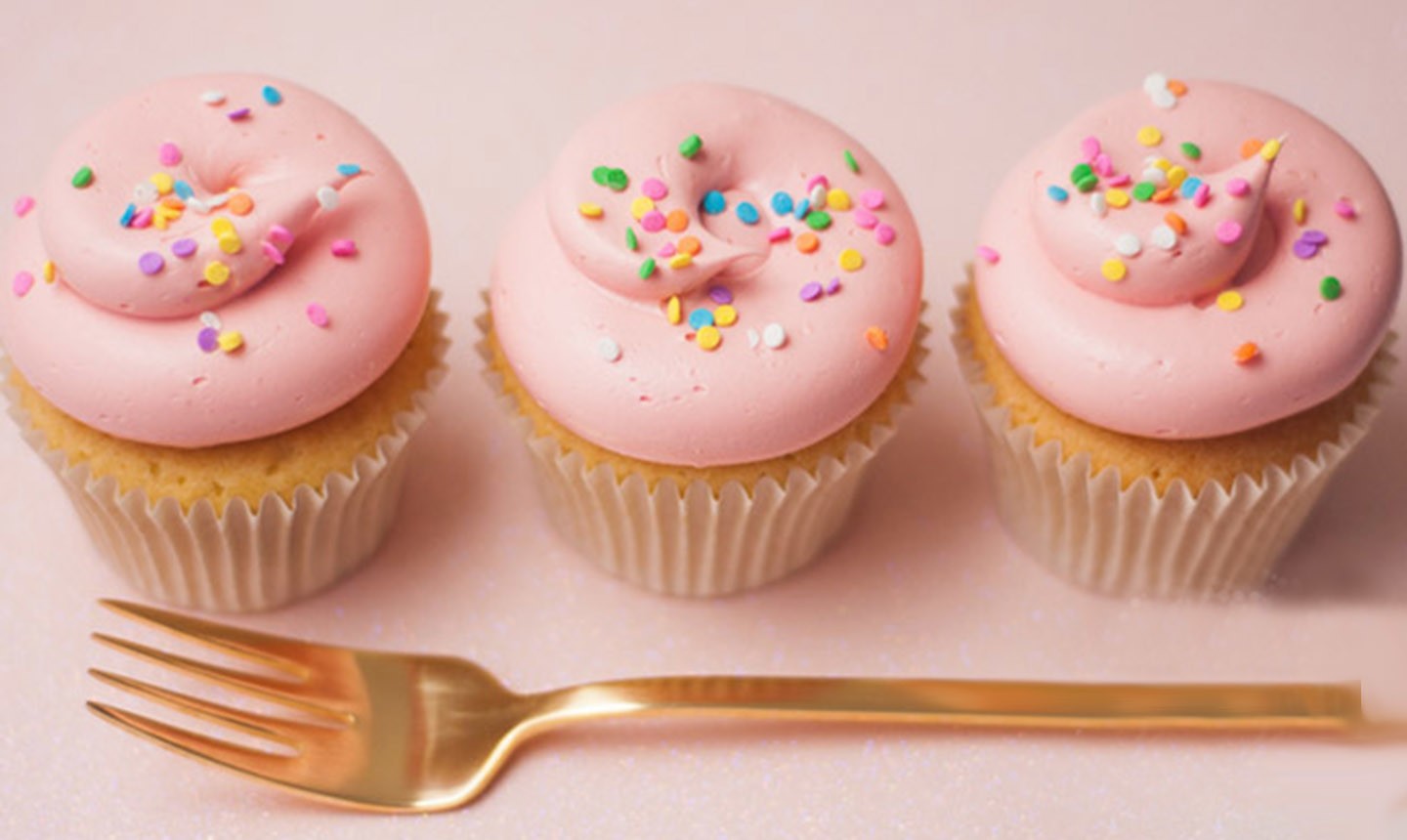 pink cucpakes decorated with funfetti