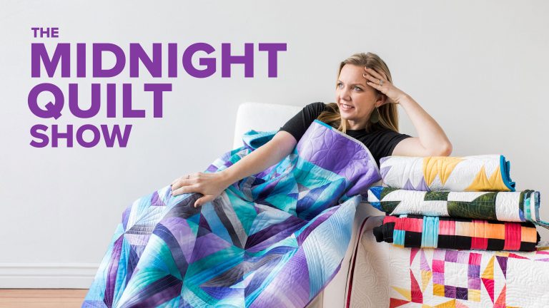 Person sitting in a chair with quilts