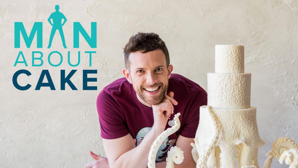 Man posing near an octopus cake