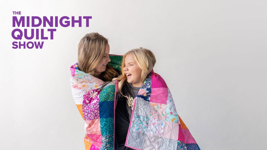 Two people wrapped in a quilt