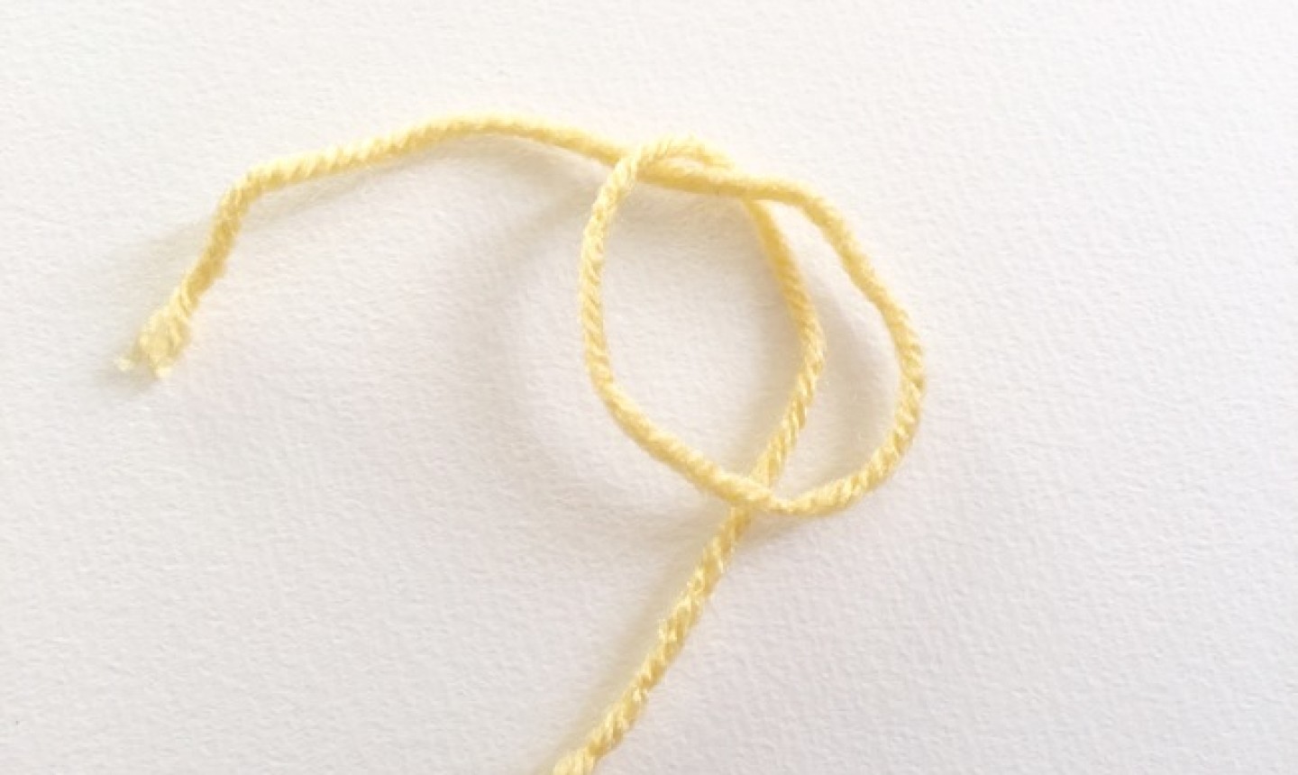 Piece of yellow yarn knotted