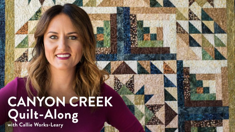 Woman in front of a canyon creek quilt