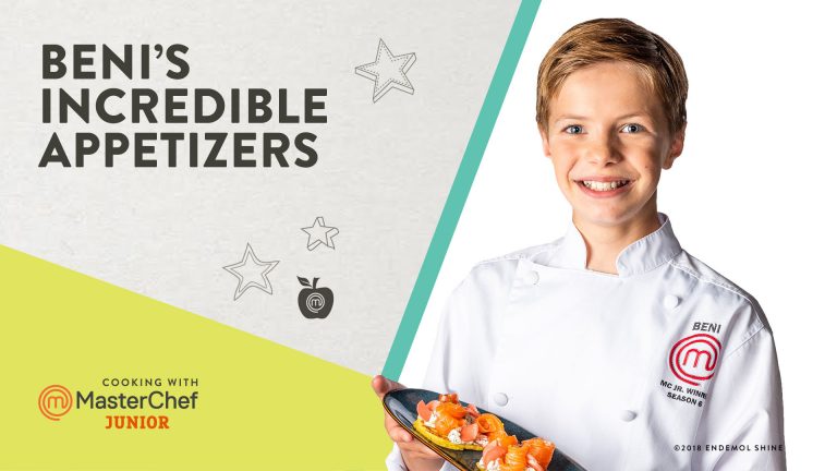 Kid holding a plate of food in a chef's coat