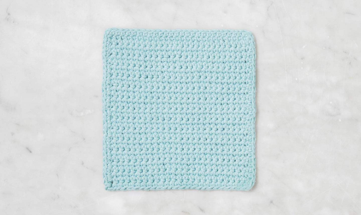 Light blue square of completed crochet