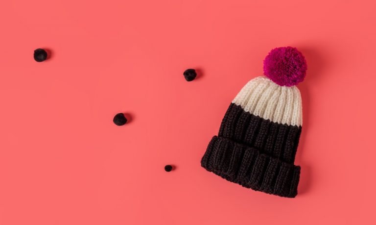 Black and white color block hat with pink pom